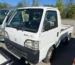 White Honda Acty kei truck viewed from the front and side
